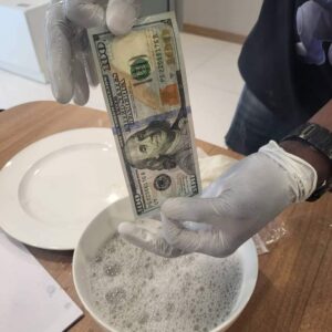 Black dollar currency cleaning chemical